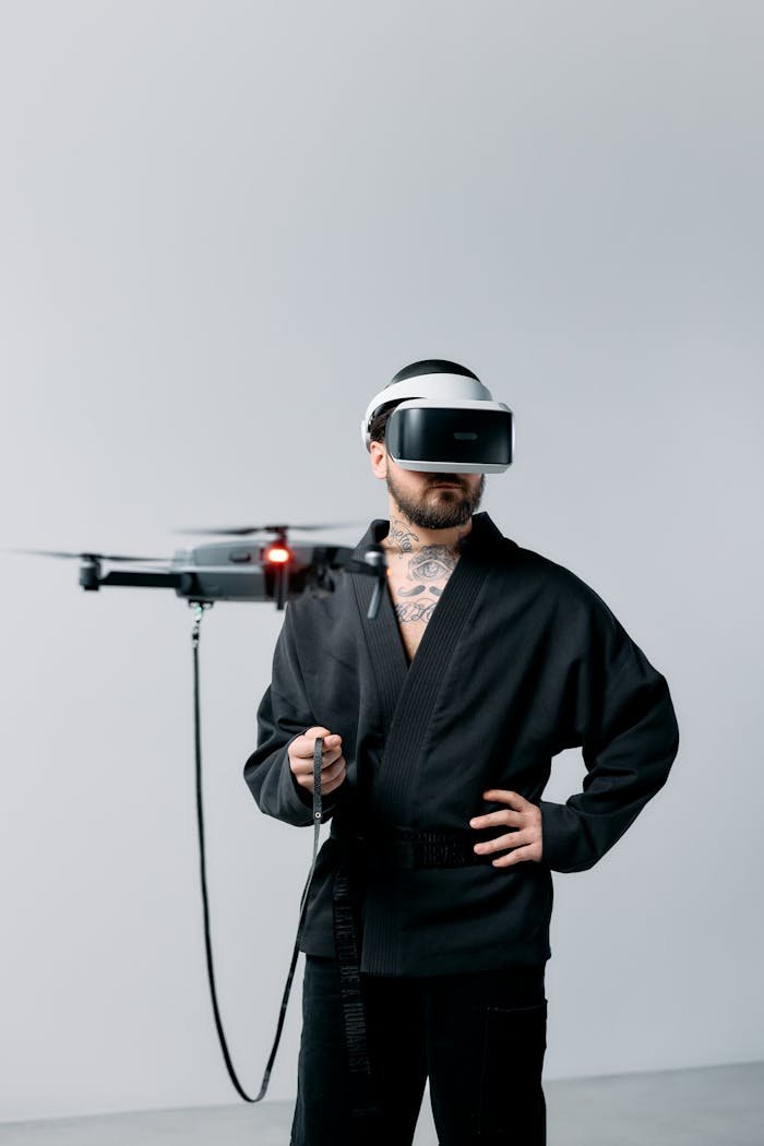 Man wearing a VR headset controls a drone indoors. Futuristic technology setting.